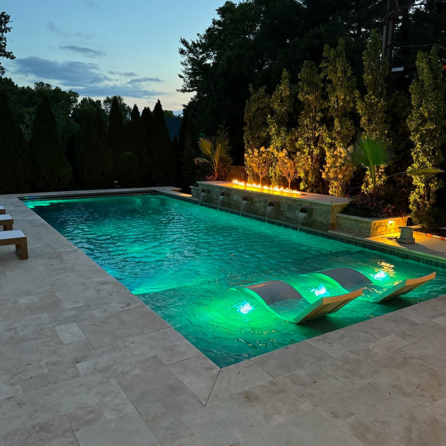 Custom pool with LED lighting and in-pool loungers